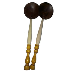 Handmade coconut shell spoon with a long palm wood handle, ideal for serving curries or rice.